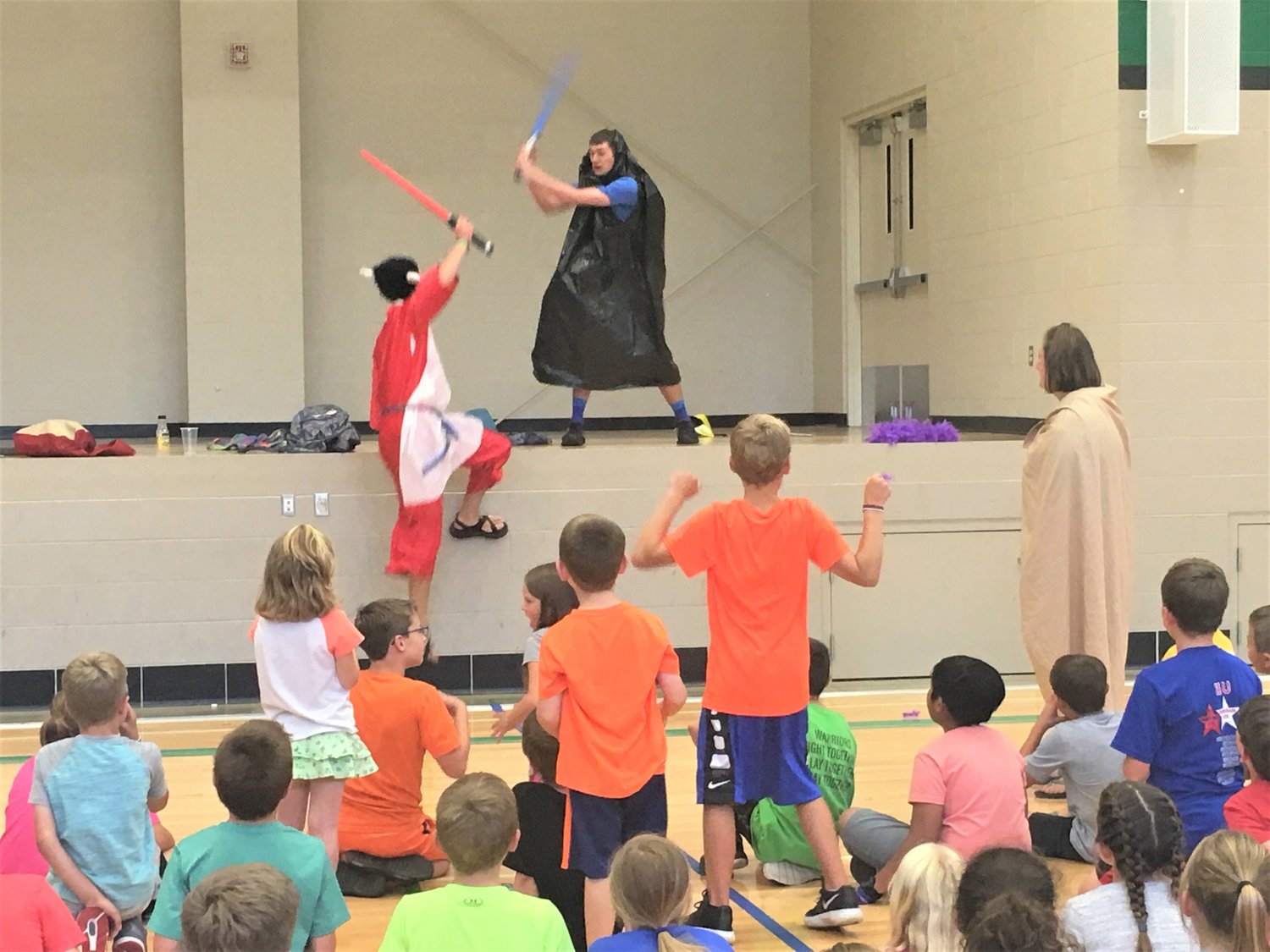Children of Ss. Peter & Paul in Boonville and surrounding parishes watch teenagers clash with light sabers this summer during Totus Tuus, a weeklong, parish-based summer experience for Catholic youth.